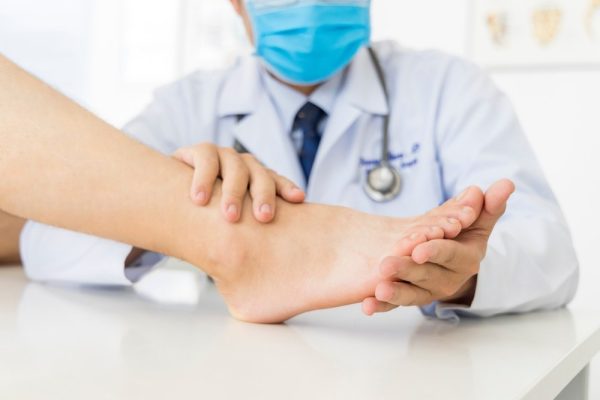 Doctor examining the foot of a patient in Ohr medical clinic